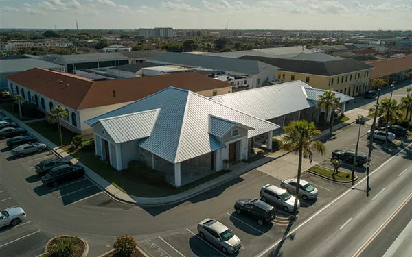 Aerial view of a commercial office building in Port Orange, Florida, featuring a newly installed standing seam metal roofing system by GRIT Roofing.
