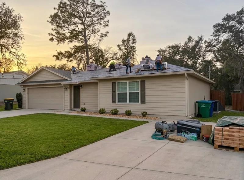 GRIT Roofing contractors performing a residential roof replacement on a single-story home in Deltona, Florida.